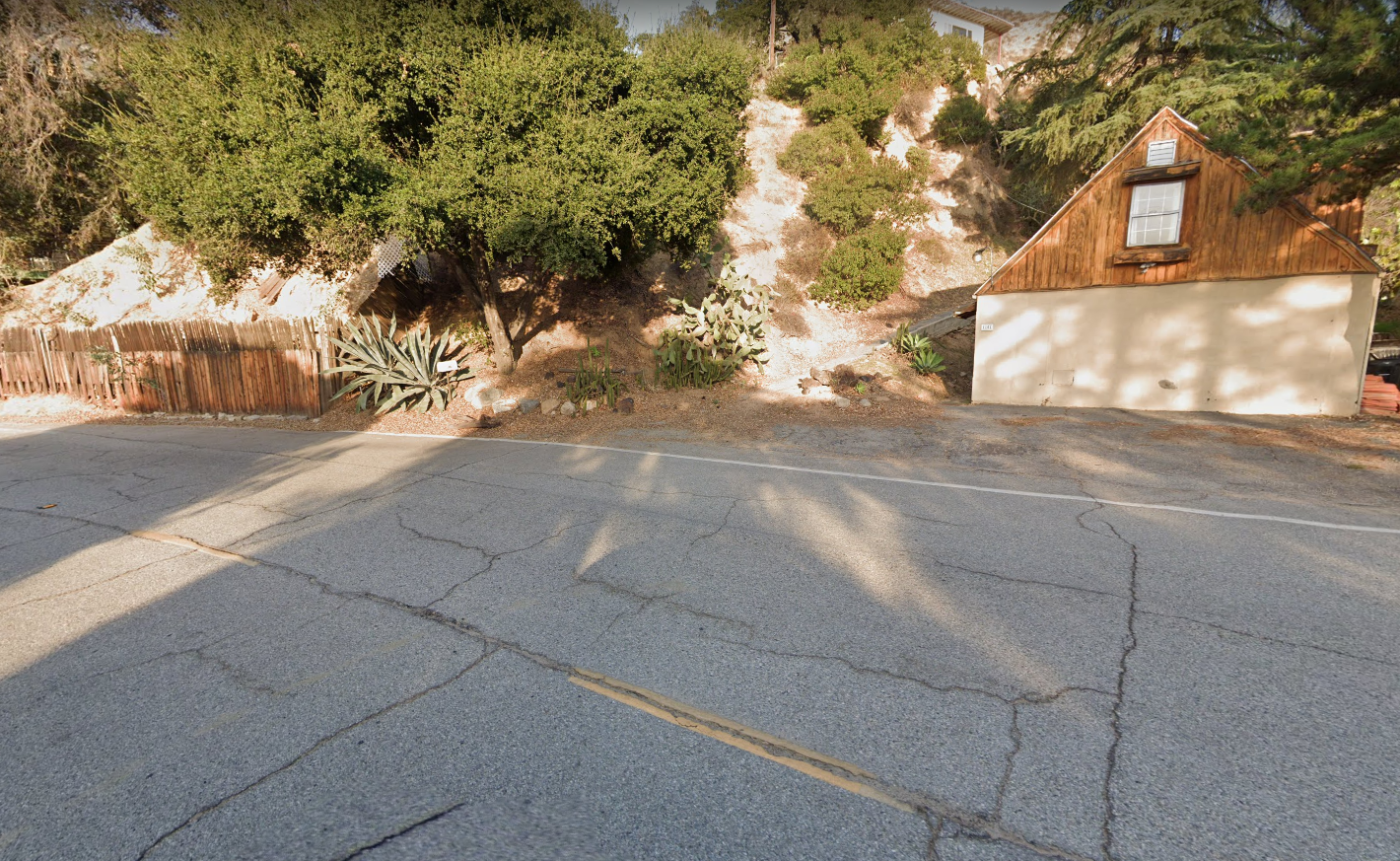 a house and hillside along the section of road known as Gravity Hill